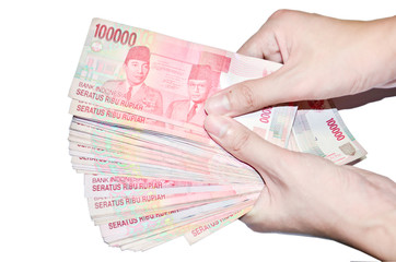 woman hand holding money Indonesia, isolated on white background