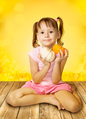 Girl holding pumpkins