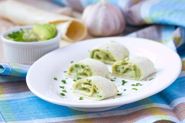 Rolls wrapped bread, tortilla, pita stuffed with avocado cream