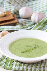 Green garlic cream soup with leaves rukola, arugula, healthy