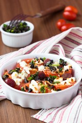 Tomatoes baked with cheese feta, smoked sausages, herbs, olives