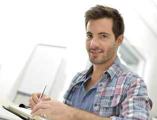 Smiling office worker sitting at desk