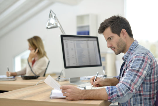 Man working in office in front of desktop