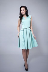 Beautiful young woman in a turquoise dress