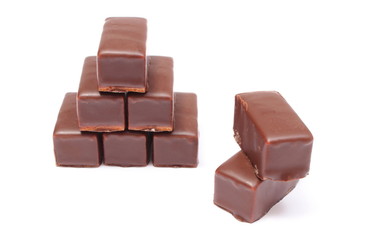 Stack of chocolate sweets on white background