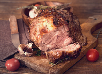 Sliced roasted pork on board