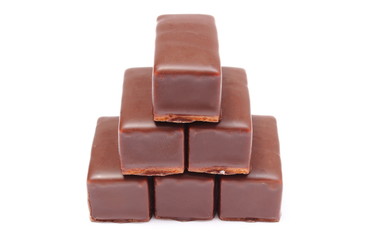 Stack of chocolate sweets on white background