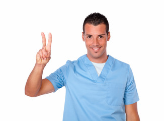 Naklejka premium Excited male nurse smiling with victory sign
