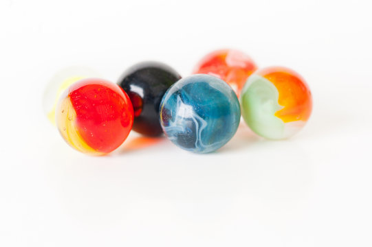 close up of glass marbles on white background