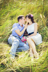 Fototapeta premium Girl with a guy lying in the tall grass