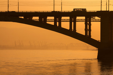 Fototapeta na wymiar Bridge over a large river. Construction with steel.