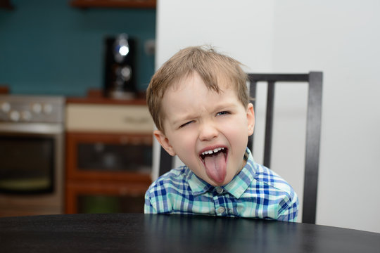 4 year old boy shows his tongue