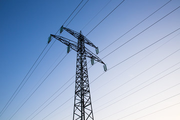 Electric power lines against blue sky