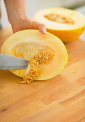Closeup on woman cutting melon
