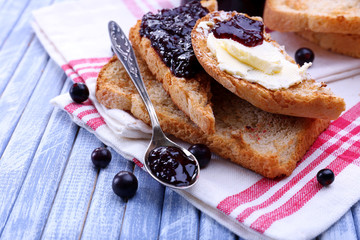 Delicious toast with jam on table close-up