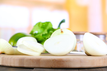 Cut onion on cutting board on wooden background