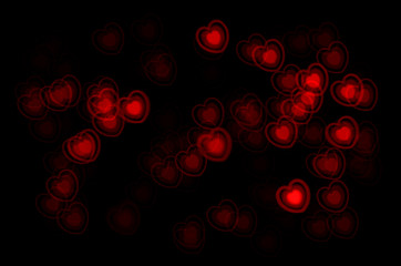various red hearts against a black background