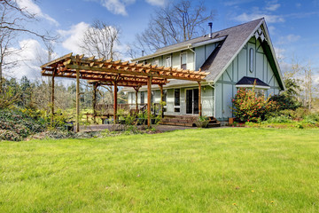 Beautiful farmhouse with attached pergola. Early spring