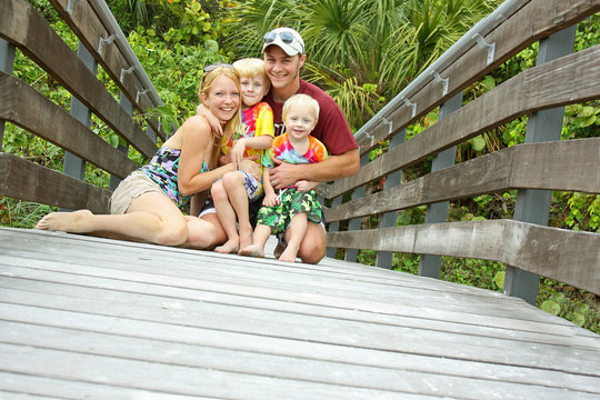 Happy Family On Tropical Boardwalk