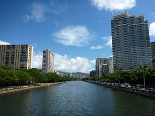 Fototapeta na wymiar Ala Wai Canal, hotels, Condos, and trees on a nice day in Waikik