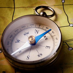 Compass lying on a map