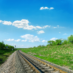 Fototapeta premium railroad in green landscape and blue sky