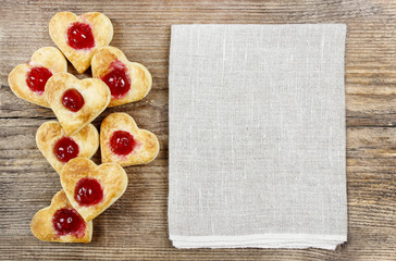 Puff pastry cookies in heart shape filled with cherries