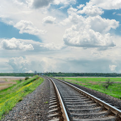 Fototapeta na wymiar railroad to horizon and cloudy sky