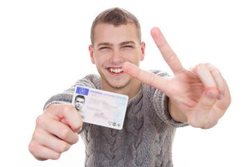 Young man showing his driver license - 60939820