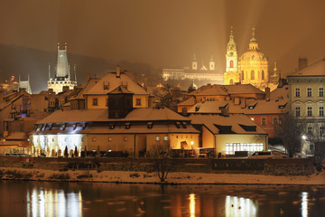 Obraz premium Night romantic snowy Prague St. Nicholas' Cathedral