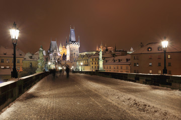 Obraz premium Night snowy Prague gothic Castle and St. Nicholas' Cathedral