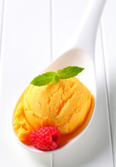 Yellow ice cream on spoon