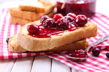 Delicious toast with jam on table close-up