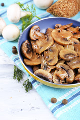 Delicious fried mushrooms in pan on table close-up