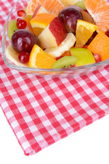 Sweet fresh fruits in bowl on table close-up