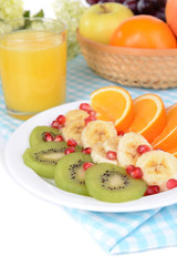 Sweet fresh fruits on plate on table close-up