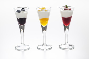 Still life of yogurt, berries, peach and jam