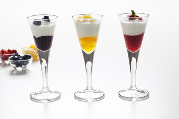 Still life of yogurt, berries, peach and jam