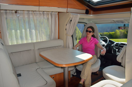 Woman in camper (RV) interior, family travel and vacation