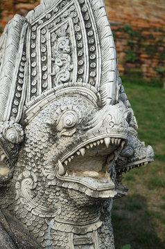 Carved stone statue protecting part of the Buddhist temple