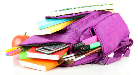 Purple backpack with school supplies isolated on white © Africa Studio