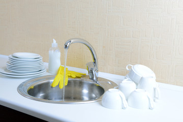 Dishes drying near  metal sink