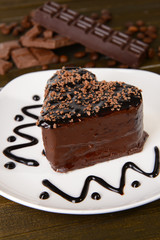 Sweet cake with chocolate on plate on table close-up
