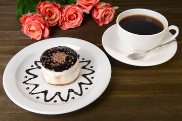 Sweet cake with chocolate on plate on table close-up