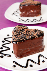 Sweet cakes with chocolate on plate on table close-up
