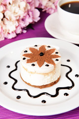 Sweet cake with chocolate on plate on table close-up