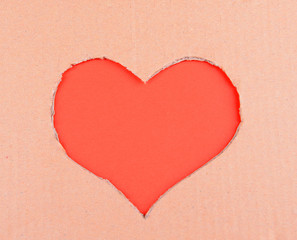 Naklejka na ściany i meble Cardboard heart on red background