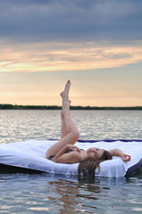 The girl woke up in a bed on water