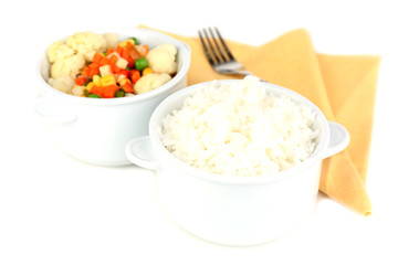 Cooked rice and vegetables isolated on white