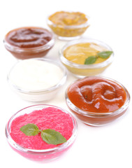Various sauces isolated on white